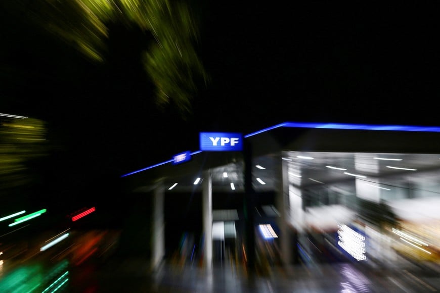 FILE PHOTO: The logo of Argentina's state energy company YPF is seen at a gas station, in Buenos Aires, Argentina February 10, 2021. Picture taken with a slow shutter speed and a zoom effect. Picture taken February 10, 2021. REUTERS/Matias Baglietto/File Photo