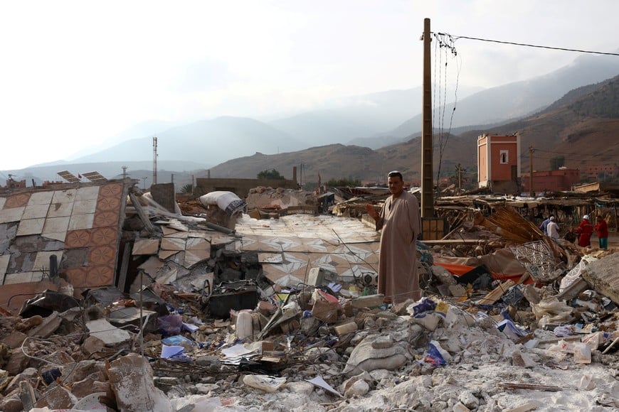 A man stands amid rubble in the aftermath of a deadly earthquake in Talat N'Yaaqoub, in Morocco September 12, 2023. REUTERS/Hannah McKay