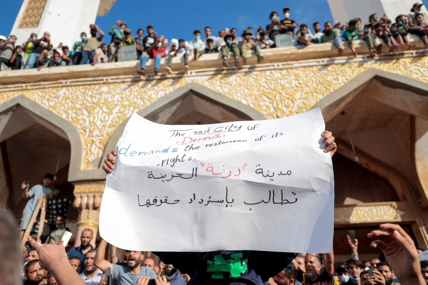People who survived the deadly storm that hit Libya, protest outside the Al Sahaba mosque against the government in Derna, Libya September 18, 2023. The sign reads: "The sad city of Derna demands its rights". REUTERS/Zohra Bensemra??