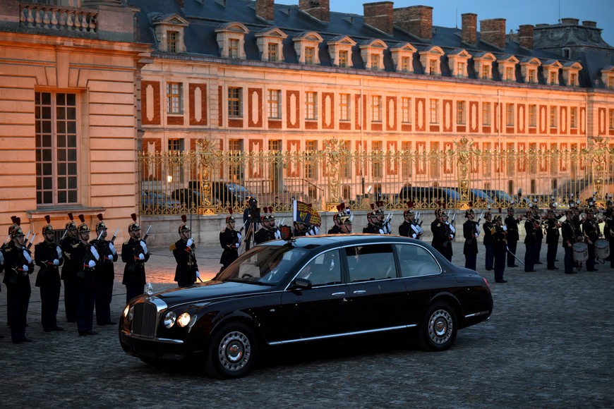 Britain's King Charles and Britain's Queen Camilla sit in a car as they arrive for a state banquet at the Palace of Versailles, west of Paris, on September 20, 2023, on the first day of a British royal state visit to France. Britain's King Charles and his wife Queen Camilla are on a three-day state visit to France.     DANIEL LEAL/Pool via REUTERS
