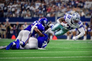 Sep 8, 2019; Arlington, TX, USA; Dallas Cowboys running back Ezekiel Elliott (21) dives over New York Giants free safety Jabrill Peppers (21) and free safety Antoine Bethea (41) during the second half at AT&T Stadium. Mandatory Credit: Jerome Miron-USA TODAY Sports
