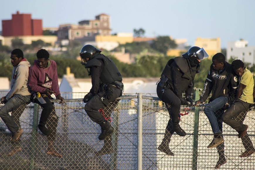 melilla inmigrantes tratan de cruzar hacia melilla saltando la reja alambrado de separacion 


African migrants sit atop a border fence, as Spanish Civil Guard officers in riot gear climb up to force them to climb down during an attempt to cross into Spanish territories, between Morocco and Spain's north African enclave of Melilla October 22, 2014. Around 400 migrants attempted to cross the border into Spain, according to local media.  REUTERS/Jesus Blasco de Avellaneda  (SPAIN - Tags: SOCIETY IMMIGRATION)
A member of the Spanish Guardia Civil climbs as would-be immigrants stand atop a boarder fence separating Morocco from the north African Spanish enclave of Melilla on October 22, 2014, following a morning assault on the boarder in an attempt to cross into Spain. The flow of migrants scrambling to reach Spain's north African territory Melilla is at double the rate of last year, an official said on October 21 as he defended police after a video showed abuse by border guards. The head of the Spanish government delegation in the territory, Abdelmalik El Barkani, said the number of attempts by desperate migrants to scale the seven-metre (23-foot), triple-layer fence separating Melilla from Morocco has surged in 2014.    AFP PHOTO/ BLASCO AVELLANEDA melilla  melilla inmigrantes tratan de cruzar hacia melilla saltando la reja de separacion inmigracion ilegal inmigrantes ilegales