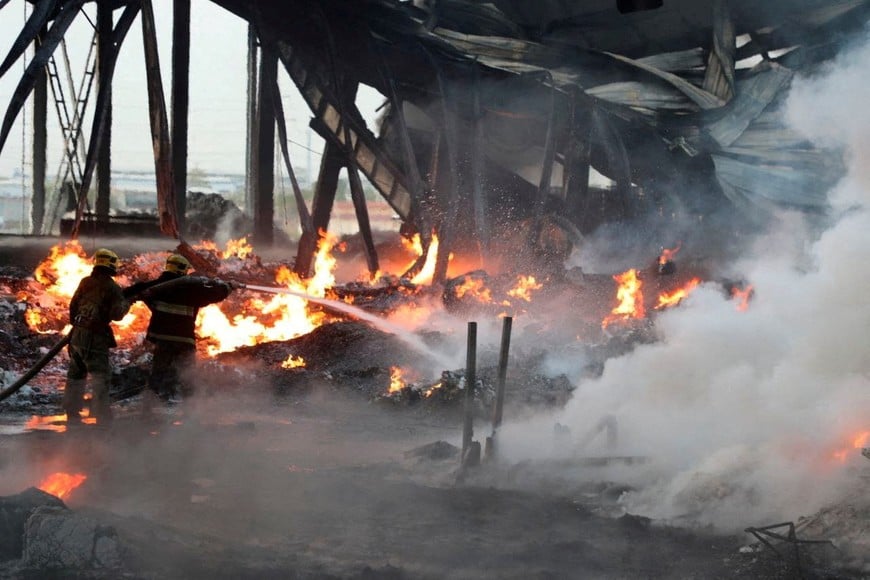 Specialists work to extinguish fire following an explosion at a warehouse near an airport in Tashkent, Uzbekistan, in this picture released September 28, 2023. Government of Uzbekistan/Handout via REUTERS ATTENTION EDITORS - THIS IMAGE WAS PROVIDED BY A THIRD PARTY. NO RESALES. NO ARCHIVES. MANDATORY CREDIT.     TPX IMAGES OF THE DAY