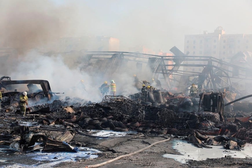 Specialists work to extinguish fire following an explosion at a warehouse near an airport in Tashkent, Uzbekistan, in this picture released September 28, 2023. Government of Uzbekistan/Handout via REUTERS ATTENTION EDITORS - THIS IMAGE WAS PROVIDED BY A THIRD PARTY. NO RESALES. NO ARCHIVES. MANDATORY CREDIT.