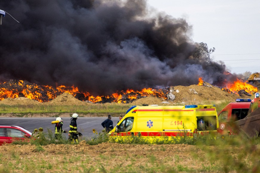 Firefighters walk next to the fire at Drava International factory near Osijek, Croatia, October 4, 2023. REUTERS/Antonio Bronic
