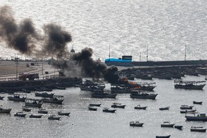 Smoke billows from a boat following Israeli strikes, at Port of Gaza, October 8, 2023. REUTERS/Mohammed Salem     TPX IMAGES OF THE DAY