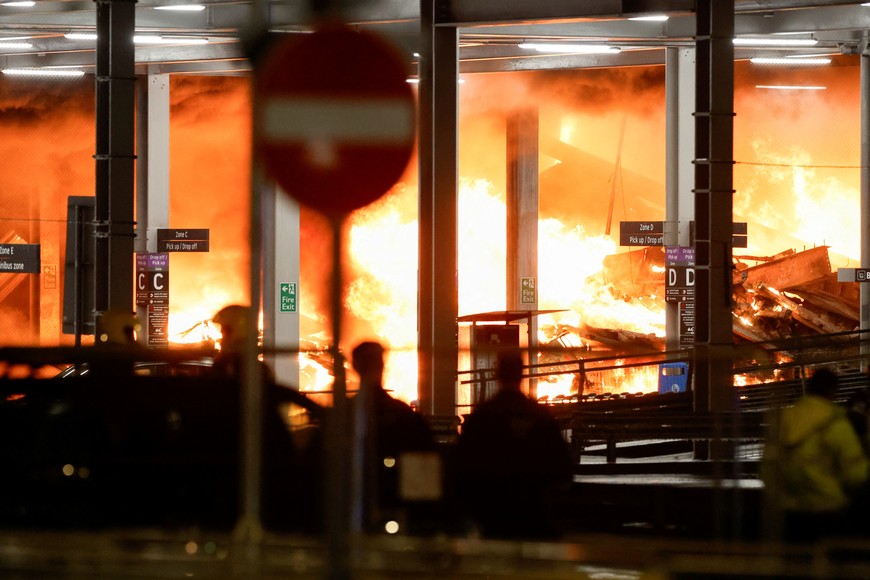Flames are seen as emergency services respond to a fire in Terminal Car Park 2 at London Luton airport in Luton, Britain, October 10, 2023.  REUTERS/Peter Cziborra