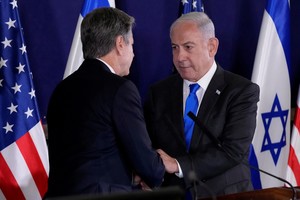 U.S. Secretary of State Antony Blinken and Israel’s Prime Minister Benjamin Netanyahu shake hands after their statements to the media inside The Kirya, which houses the Israeli Ministry of Defense, after their meeting in Tel Aviv, Israel, Thursday Oct. 12, 2023. Jacquelyn Martin/Pool via REUTERS