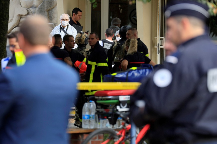 French rescue workers and police work at the site after a teacher was killed and several people injured in a knife attack at the Lycee Gambetta-Carnot high school in Arras, northern France, October 13, 2023. REUTERS/Pascal Rossignol