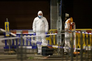 People work as Belgian police secure the area after a shooting in Brussels, Belgium, October 16, 2023. REUTERS/Johanna Geron