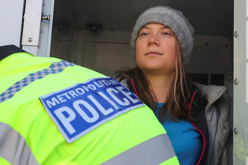 Swedish climate campaigner Greta Thunberg is put in the back of a police van, while being detained, during an Oily Money Out and Fossil Free London protest in London, Britain, October 17, 2023. REUTERS/Toby Melville