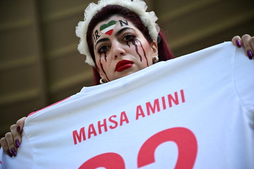 Soccer Football - FIFA World Cup Qatar 2022 - Group B - Wales v Iran - Ahmad Bin Ali Stadium, Al Rayyan, Qatar - November 25, 2022
An Iran fan is holds a t-shit in memory of Mahsa Amini, inside the stadium before the match REUTERS/Dylan Martinez     TPX IMAGES OF THE DAY