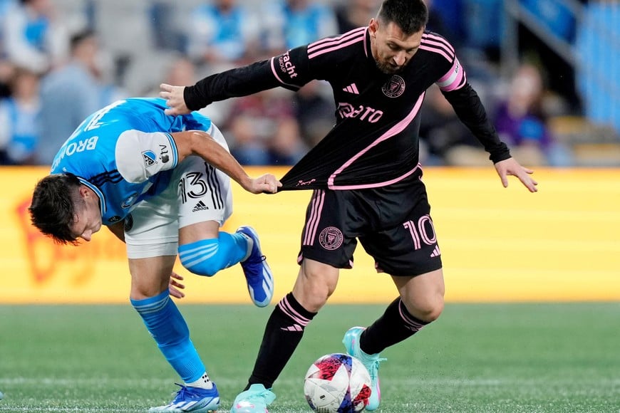 Oct 21, 2023; Charlotte, North Carolina, USA; Charlotte FC midfielder Brandt Bronico (13) battles for the ball against Inter Miami CF forward Lionel Messi (10) during the first half at Bank of America Stadium. Mandatory Credit: Jim Dedmon-USA TODAY Sports