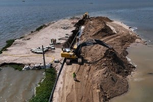 Las máquinas entierran los últimos metros de caños que atravesaron la laguna y unieron El Chaquito y Rincón. Foto: Fernando Nicola