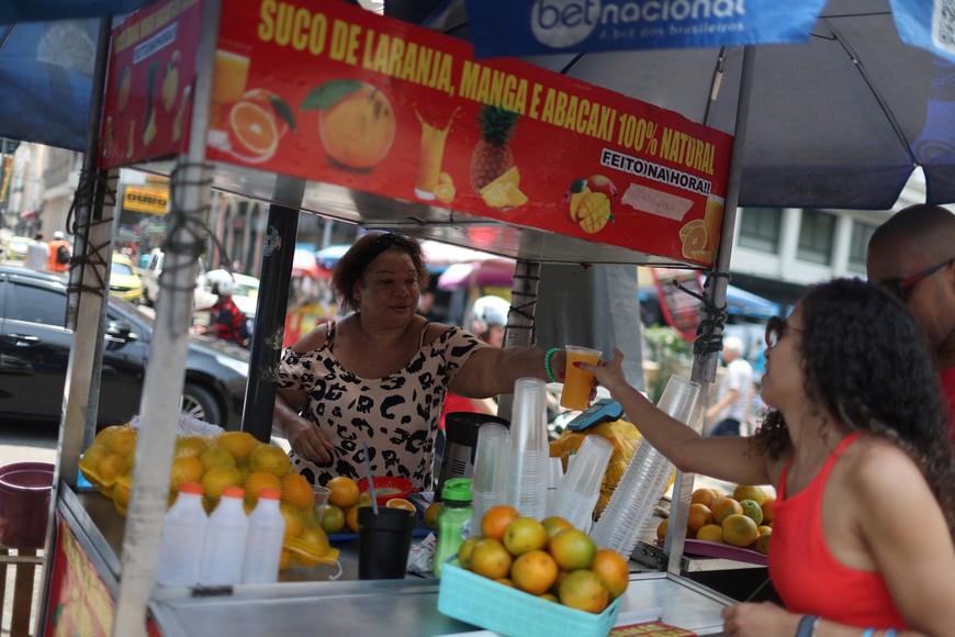 A woman sells orange juice amid a heat wave, at the street in Rio de Janeiro, Brazil November 17, 2023. REUTERS/Pilar Olivares