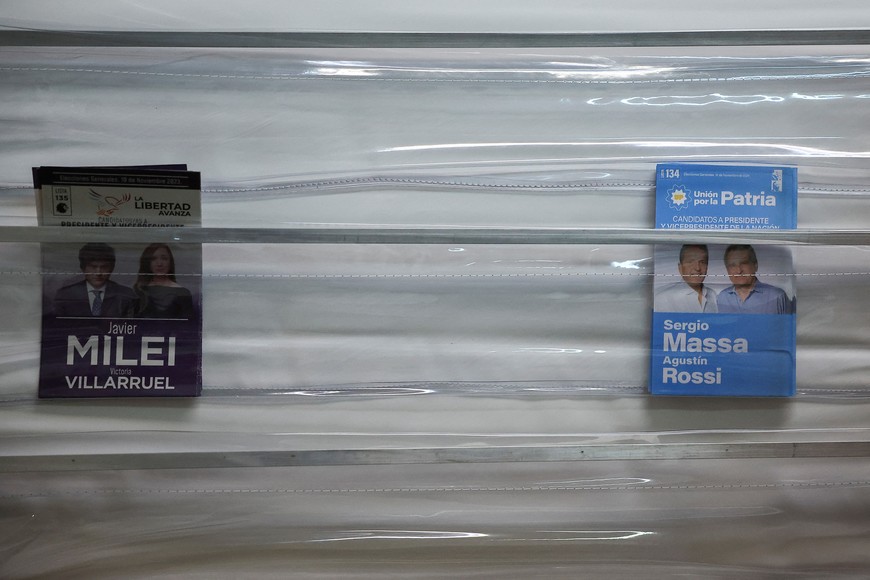 Election leaflets for Argentine presidential candidates Javier Milei and Sergio Massa are displayed in a polling station, during Argentina's runoff presidential election, in Buenos Aires, Argentina November 19, 2023. REUTERS/Agustin Marcarian