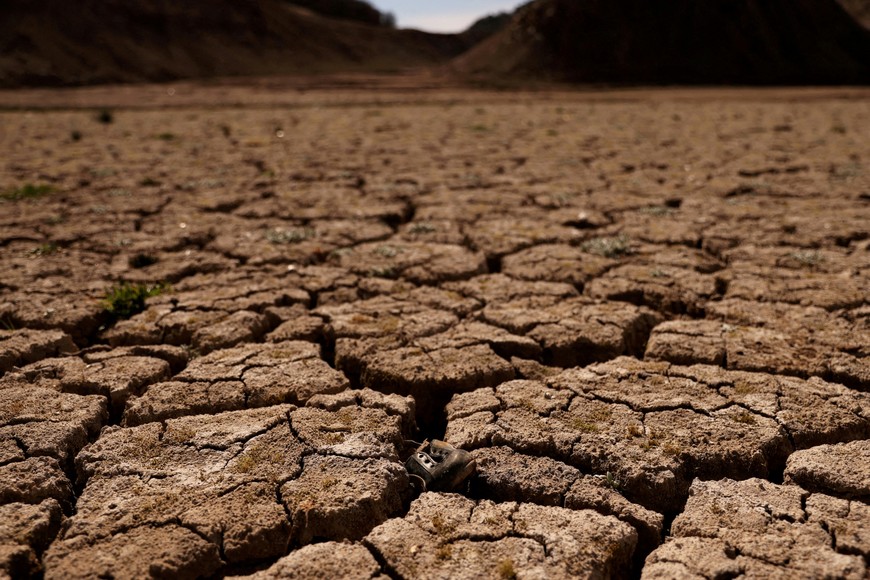 FILE PHOTO: A football shoe is pictured on the cracked ground of the Baells reservoir as drinking water supplies have plunged to their lowest level since 1990 due to extreme drought in Catalonia, in the village of Cersc, in the region Bergueda, Spain March 14, 2023. REUTERS/Nacho Doce/File Photo