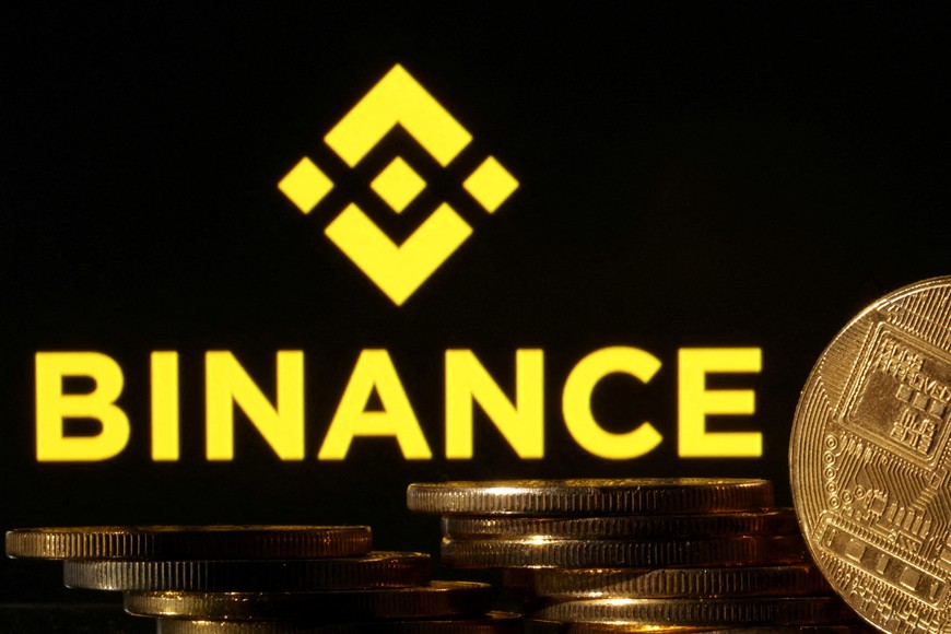 FILE PHOTO: Representations of cryptocurrencies are seen in front of displayed Binance logo in this illustration taken November 10, 2022. REUTERS/Dado Ruvic/Illustration/File Photo