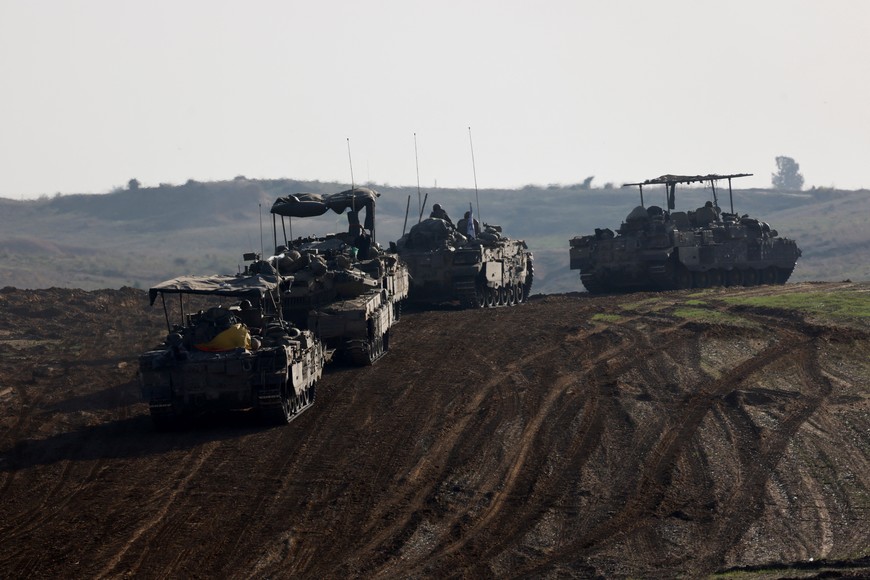 Israeli military vehicles move near Israel's border after leaving Gaza, during the temporary truce between the Palestinian Islamist group Hamas and Israel, in Israel, November 24, 2023. REUTERS/Amir Cohen
