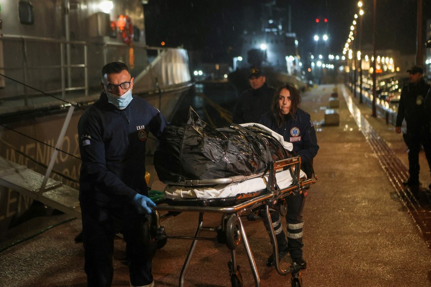 Medical personnel carry the body of a crew member of a cargo ship following a rescue operation, after the vessel sank off the island of Lesbos, Greece, November 26, 2023. REUTERS/Elias Marcou
