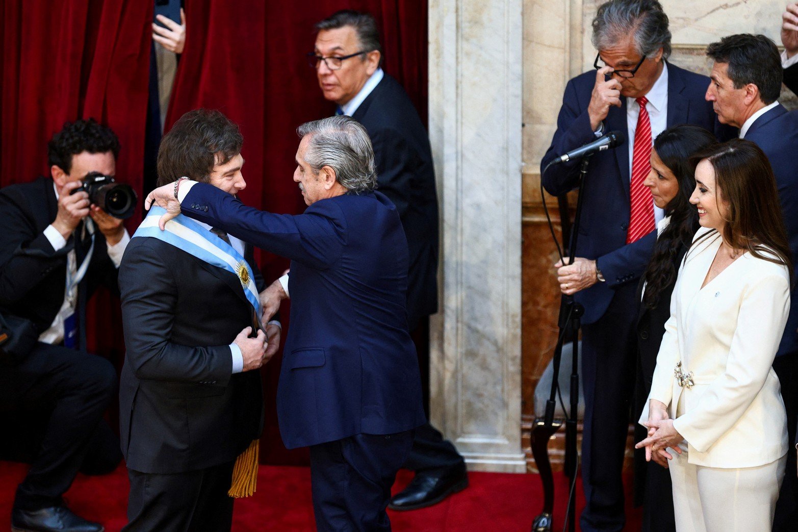 Outgoing Argentine President Alberto Fernandez passes the presidential sash to Javier Milei after he was sworn in as Argentina's next president, in Buenos Aires, Argentina December 10, 2023. REUTERS/Matias Baglietto