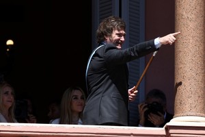 Argentina's President Javier Milei gestures to supporters from the Casa Rosada balcony, as his sister Karina Milei and his partner Fatima Florez look on, after his swearing-in ceremony, in Buenos Aires, Argentina December 10, 2023. REUTERS/Agustin Marcarian