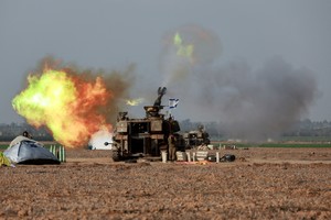 An Israeli artillery unit operates near the border with Gaza, amid the ongoing conflict between Israel and Palestinian Islamist group Hamas, as seen from southern Israel, December 12, 2023. REUTERS/Ammar Awad