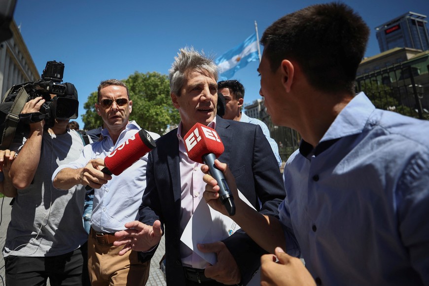 Argentina's Economy Minister Luis Caputo speaks to the media as he leaves the Casa Rosada Presidential Palace one day after the inauguration of Argentina's President Javier Milei, in Buenos Aires, Argentina December 11, 2023. REUTERS/Agustin Marcarian