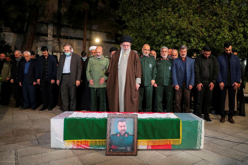 Iran's Supreme Leader, Ayatollah Ali Khamenei pray next to the coffin of senior adviser for Iran's Revolutionary Guards, Sayyed Razi Mousavi, who was killed in an Israeli air strike outside the Syrian capital Damascus, during his funeral in Tehran, Iran December 28, 2023. Office of the Iranian Supreme Leader/WANA (West Asia News Agency) via REUTERS ATTENTION EDITORS - THIS PICTURE WAS PROVIDED BY A THIRD PARTY