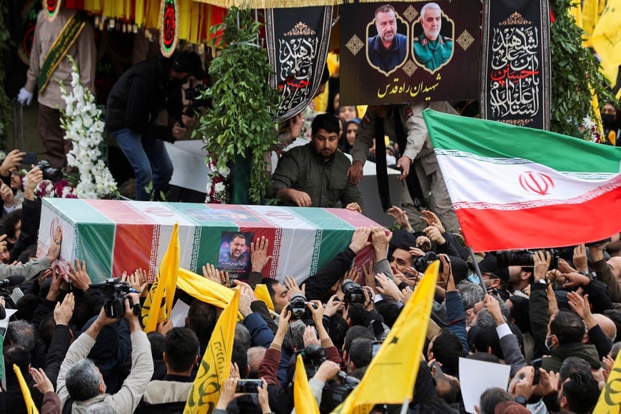 People carry the coffin of senior adviser for Iran's Revolutionary Guards, Sayyed Razi Mousavi, who was killed in an Israeli air strike outside the Syrian capital Damascus, during his funeral in Tehran, Iran December 28, 2023. Majid Asgaripour/WANA (West Asia News Agency) via REUTERS ATTENTION EDITORS - THIS IMAGE HAS BEEN SUPPLIED BY A THIRD PARTY.