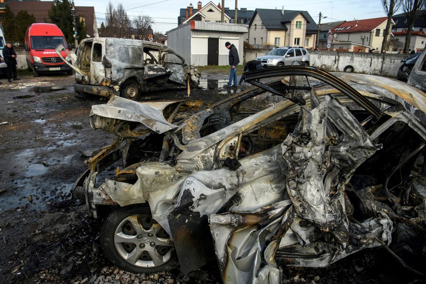 FILE PHOTO: A man walks next to a car destroyed during a Russian missile and drone strike, amid Russia's attack on Ukraine, in Kyiv, Ukraine December 29, 2023. REUTERS/Vladyslav Musiienko/File Photo