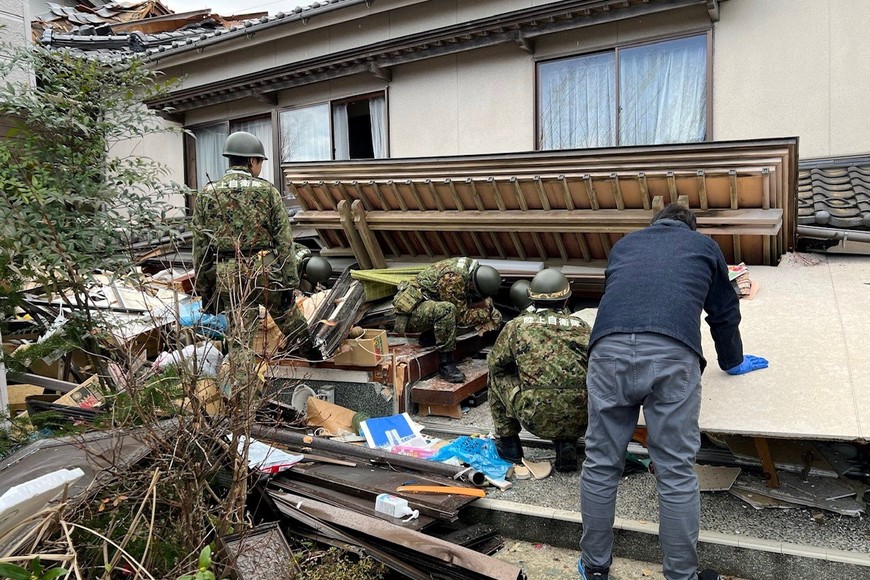 Japanese Self-Defense Force soldiers conduct rescue operations at a collapsed house caused by an earthquake in Wajima, Ishikawa prefecture, Japan January 2, 2024, in this handout photo released by the Joint Staff Office of the Defense Ministry of Japan. Joint Staff Office of the Defense Ministry of Japan/HANDOUT via REUTERS ATTENTION EDITORS - THIS IMAGE WAS PROVIDED BY A THIRD PARTY.  MANDATORY CREDIT.