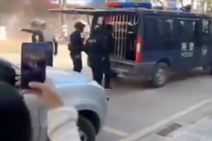 Members of security stand near a police vehicle following an explosion after artillery shells fell in Nansan, Yunnan Province, China, in this screengrab obtained from a social media video, released on January 3, 2024. Video Obtained By Reuters/via REUTERS  THIS IMAGE HAS BEEN SUPPLIED BY A THIRD PARTY. NO RESALES. NO ARCHIVES.