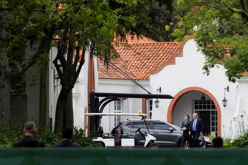 Argentina's incumbent President Alberto Fernandez and President-elect Javier Milei walk as they meet at the Olivos Presidential Residence, in Buenos Aires, Argentina November 21, 2023. REUTERS/Matias Baglietto