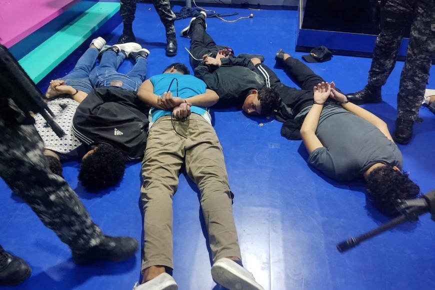 People accused of invading and taking over television station TC with weapons and forcing staff to lie and sit down, lie handcuffed on the floor in a police haundout, in Guayaquil, Ecuador, January 9, 2024. Ecuadorean Police/Handout via REUTERS  THIS IMAGE HAS BEEN SUPPLIED BY A THIRD PARTY. NO RESALES. NO ARCHIVES