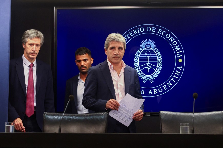 Argentina's Economy Minister Luis Caputo and Central Bank's President Santiago Bausili arrive for a press conference following a staff-level agreement with the International Monetary Fund (IMF) on the latest review of the country's $44 billion debt program, at the Economy Ministry building in Buenos Aires, Argentina, January 10, 2024. REUTERS/Matias Baglietto