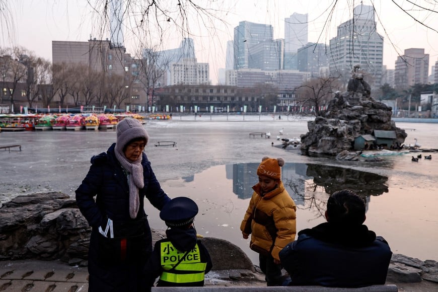 Elderly people spend time with children at a park in Beijing, China January 12, 2024. REUTERS/Tingshu Wang