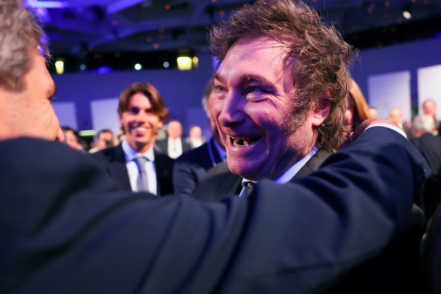 Argentina's President Javier Milei receives a hug from Minister of Economy Luis Caputo, during the 54th annual meeting of the World Economic Forum (WEF), in Davos, Switzerland, January 17, 2024. REUTERS/Denis Balibouse