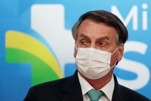 FILE PHOTO: Brazil's President Jair Bolsonaro looks on during a ceremony of signing the Vaccine Technology Transfer Agreement for Oxford/AstraZeneca coronavirus disease (COVID-19) vaccines, in Brasilia, Brazil, June 1, 2021. REUTERS/Ueslei Marcelino/File Photo
