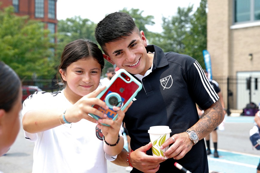 Jul 17, 2023; Washington, D.C., USA; Thiago Almada poses for a photo with a fan during the MLS WORKS and BODYARMOR community day before the 2023 MLS All Star Game at Seaton Elementary School. Mandatory Credit: Amber Searls-USA TODAY Sports