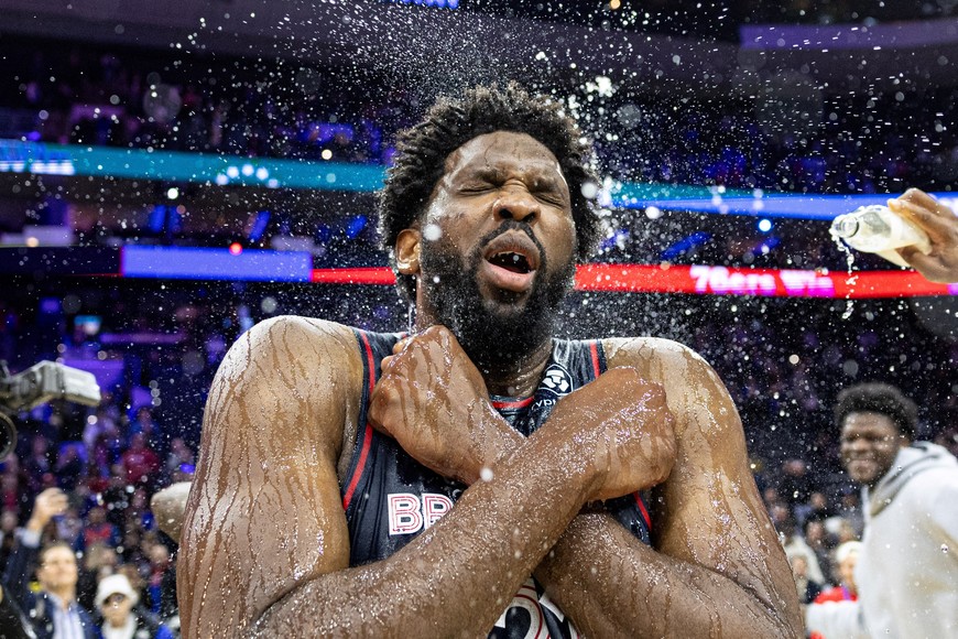 Jan 22, 2024; Philadelphia, Pennsylvania, USA; Philadelphia 76ers center Joel Embiid (21) is doused with water by teammates after scoring 70 points in a victory against the San Antonio Spurs at Wells Fargo Center. Mandatory Credit: Bill Streicher-USA TODAY Sports