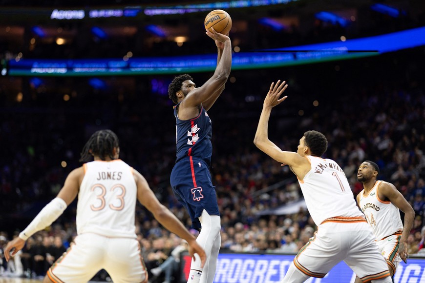 Jan 22, 2024; Philadelphia, Pennsylvania, USA; Philadelphia 76ers center Joel Embiid (21) shoots in front of San Antonio Spurs center Victor Wembanyama (1) during the second quarter at Wells Fargo Center. Mandatory Credit: Bill Streicher-USA TODAY Sports