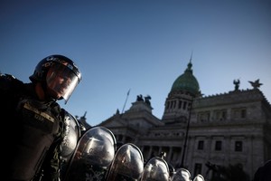 Members of the Gendarmerie stand guard outside the National Congress as demonstrators protest on the day of the debate on Argentina's President Javier Milei's economic reform bill, known as the "omnibus bill," in Buenos Aires, Argentina, January 31, 2024. REUTERS/Agustin Marcarian