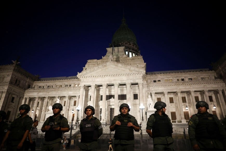 Law enforcement officers stand guard outside the National Congress during a protest as lawmakers debate on Argentina's President Javier Milei's economic reform bill, known as the "omnibus bill," in Buenos Aires, Argentina, February 1, 2024. REUTERS/Agustin Marcarian