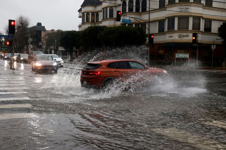 Cars drive on flooded streets, during the ongoing rain storm in Studio City, California, U.S., February 5, 2024.  REUTERS/Aude Guerrucci