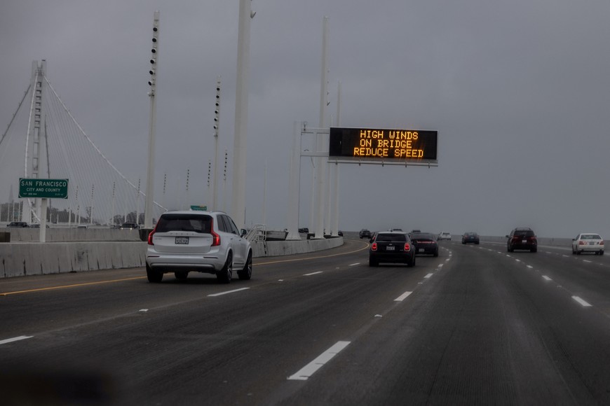 A traffic sign which reads "High Wind on bridge reduce speed" is seen as a Pacific storm known as an "Atmospheric River" approaches northern California, bringing heavy rains and winds that could trigger widespread flooding, in downtown San Francisco, California, U.S., February 4, 2024. REUTERS/Carlos Barria