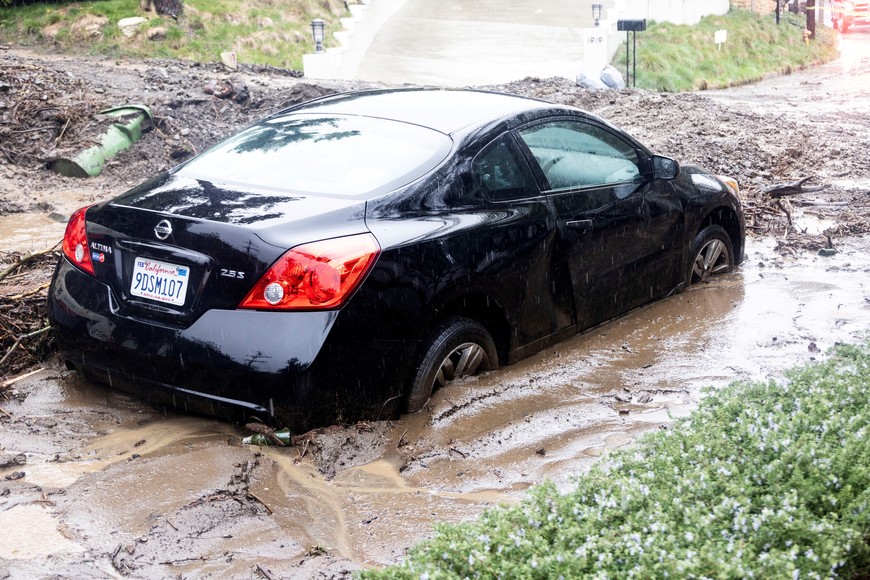 Rain falls over a car stuck by a mudslide, caused by an ongoing rain storm, in Studio City, California, U.S., February 5, 2024.  REUTERS/Aude Guerrucci