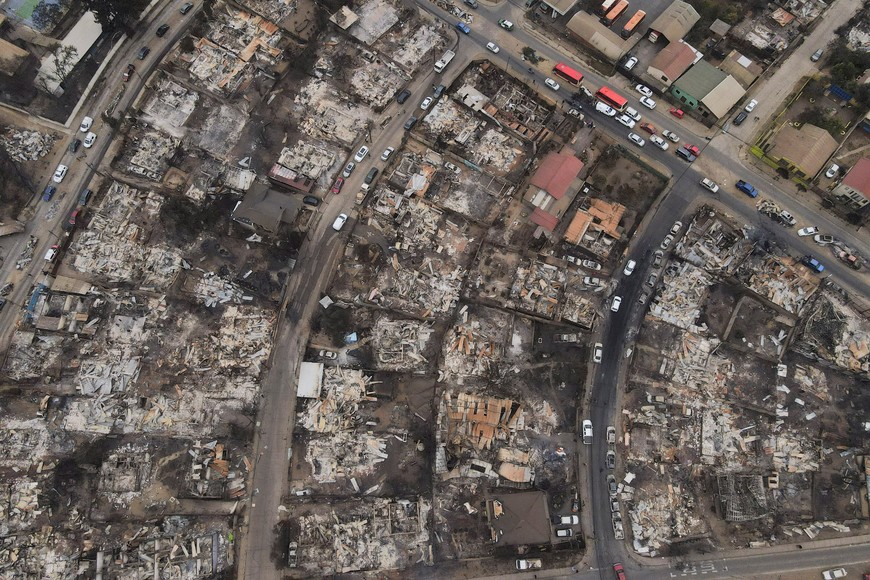 The remains of burned houses are seen, following the spread of wildfires in Vina del Mar, Chile February 4, 2024. REUTERS/ Sofia Yanjari