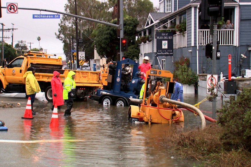 Workers pump flood water from the street surrounding the Inn at Playa del Rey, after heavy rains hit Southern California, in Los Angeles, California, U.S., February 5, 2024, as seen in this scree grab taken from a video. REUTERS/Sandra Stojanovic