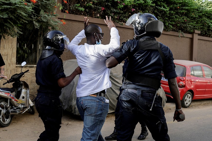 Riot police officers detain a protester who was gathering with others  to protest the postponement of the February 25 presidential election, near Senegal's National Assembly in Dakar, Senegal February 5, 2024. REUTERS/Zohra Bensemra